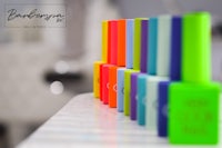 a row of colorful nail polish bottles on a counter