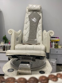 a white nail chair in a nail salon