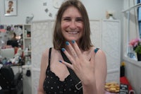 a woman in a salon with a blue ring on her finger